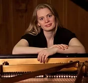 woman posing with piano